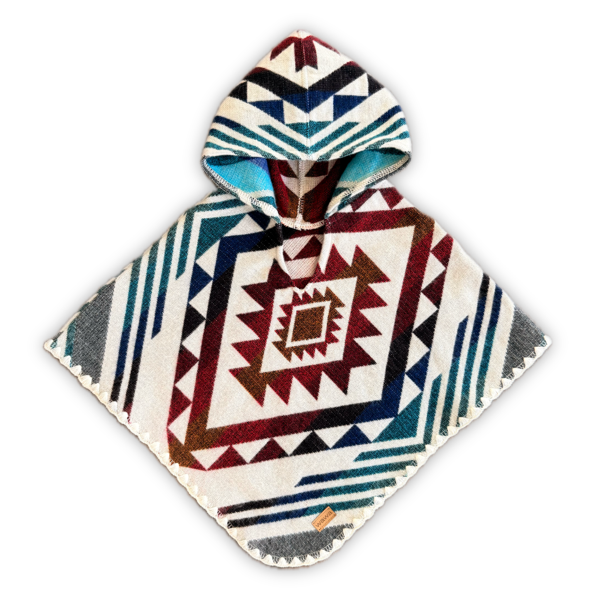 A hooded poncho with a Southwestern geometric pattern in cream, navy, red, and teal, displayed flat against a white background.